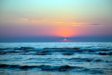 Beautiful sunset over the Baltic Sea in Jurmala, Latvia. Sea sunset view. Beautiful orange and yellow color sea sunset.	