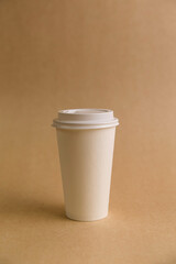 The concept of takeaway coffee, coffee in a paper white glass, the beginning of the day.