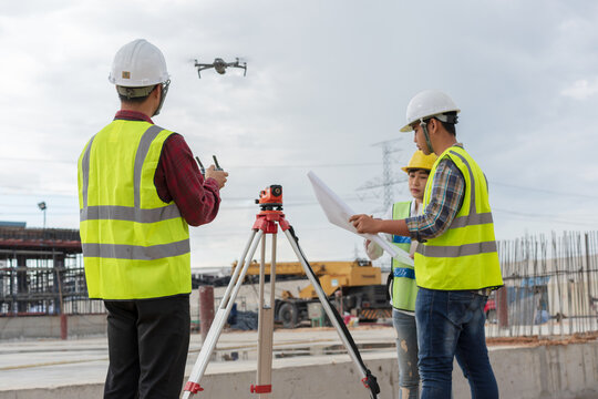 Construction concept , Engineer and Architect working with drone for inspection over construction site.