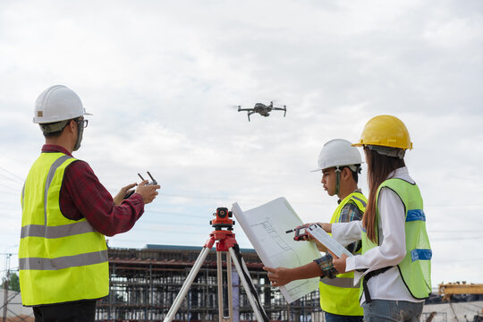 Construction concept , Engineer and Architect working with drone for inspection over construction site.