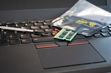 RAM is upgraded and placed in ESD packaging on a PC keyboard. The packaging protects sensitive...