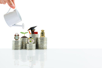 Saving money for college tuition fee concept : Hand pours water from watering can, clock, sprout /...