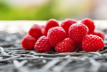 Fresh organic raspberry on a wicker napkin with copy space