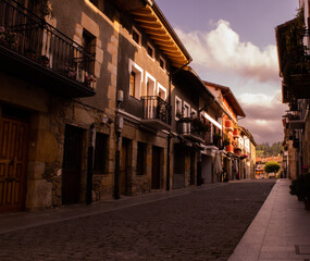 Fototapeta premium rural village street with antique houses in northern spain with cloudy skies. romantic weekend getaway