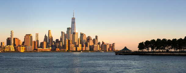 Lower Manhattan skyline and World Trade Center panoramic view at Sunset. Hudson River view of New...