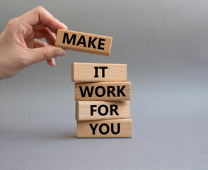 Make it work for you symbol. Business Concept words Make it work for you on wooden blocks. Beautiful grey background. Businessman hand. Business concept. Businessman hand. Copy space