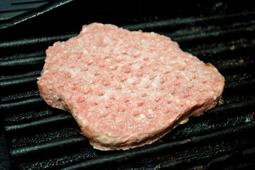 Cooking a Frozen Beef Burger on a Grill
