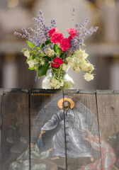 Icon of the Resurrection of Christ and a beautiful bouquet of flowers in a vase in a church