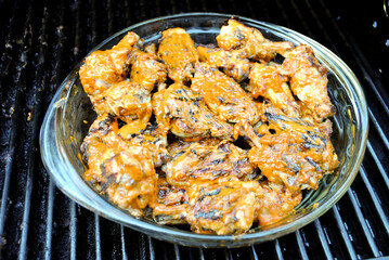 Spicy Buffalo Wings in a Serving Bowl Staying Hot on the Grill
