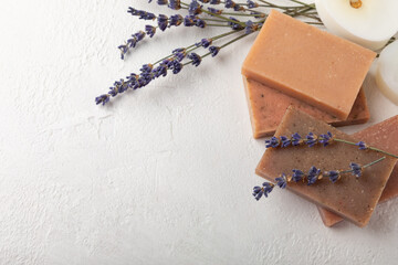 Natural lavender soap with lavender flowers on white cement background.Handmade Soap.Cosmetic product with essential oils.spa product.Space for text. Flat lay.