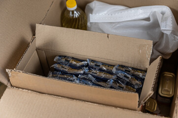 Open donation box with various groceries. Top view. Selective focus. No people.