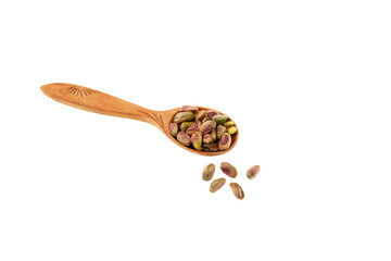 Peeled pistachios in wooden spoon on white background, selective focus. Levitation. Green pistachio. Design element