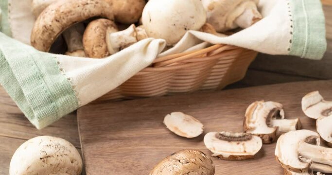 Shitaki, portobello and paris mushrooms in a basket over wooden table