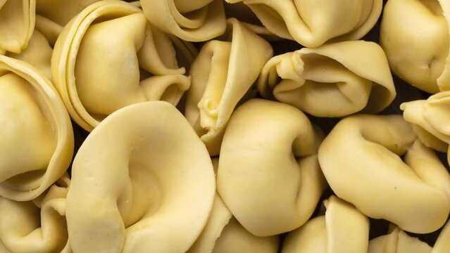 Closeup of uncooked italian pasta cappelletti or tortellini