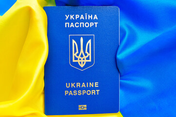 Ukrainian international biometric passport and bag for travel close up.Translation from Ukrainian: 'Ukraine,passport'