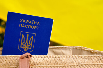 Ukrainian international biometric passport and bag for travel close up.Translation from Ukrainian:...