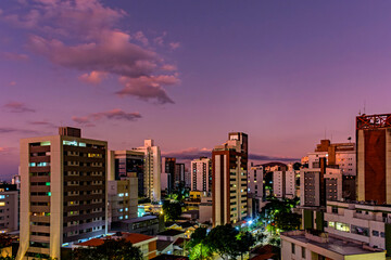 Fototapeta na wymiar Neighborhood of the city of Belo Horizonte in Minas Gerais with its buildings lit up by the sunset