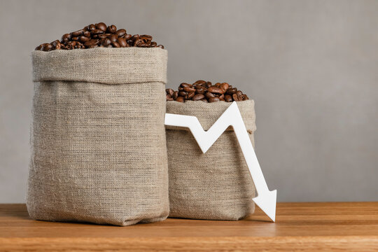 Lower prices for black coffee beans. Poor harvest of coffee beans, world food crisis. Decline in the cost of coffee futures and derivatives.Decrease graph, arrow pointing down