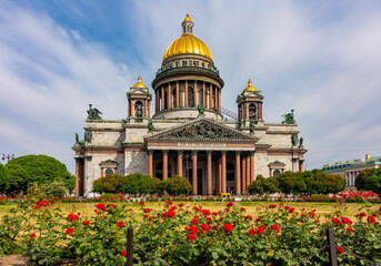 Fototapeta na wymiar St. Isaac's cathedral and blooming roses in Saint Petersburg, Russia
