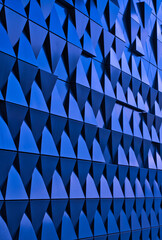 a blue metallic wall composed of triangles