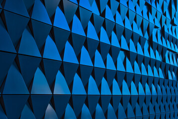 a turquoise metallic wall composed of triangles