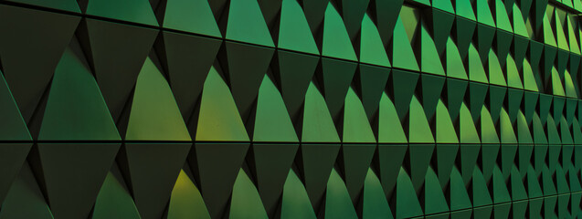 long green metallic wall made of triangles - background