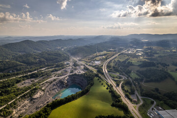 Blue Quarry Next to Highway with Green Mountains