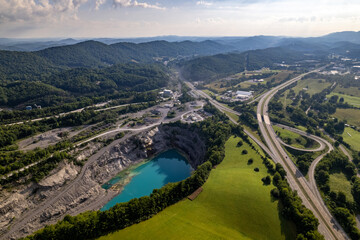 Blue Quarry Next to Highway with Green Mountains