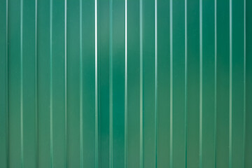 Ribbed green steel roofing and siding panel background.