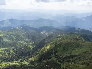 Naklejka premium Panoramic aerial view of mountains in summer. Hiking destination. Alpine meadow