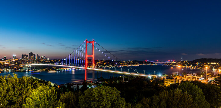 ISTANBUL, TURKEY. Panoramic view of Istanbul Bosphorus on sunset. Istanbul Bosphorus Bridge (15 July Martyrs Bridge. Turkish: 15 Temmuz Sehitler Koprusu). Beautiful cloudy blue sky.