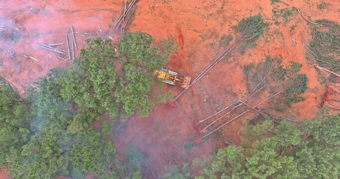 Dozer during deforest forest cleaning and preparing the land for construction an aerial view