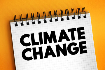 Climate change - refers to long-term shifts in temperatures and weather patterns, text concept on notepad