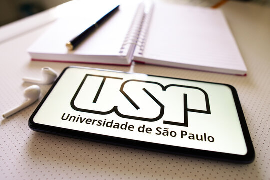 July 1, 2022, Brazil. In this photo illustration the Universidade de São Paulo (USP) logo seen displayed on a smartphone next to a book, pen and headphones.
