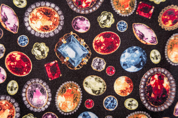 Jewel pattern print on a black textile fabric bg, diamonds and rubies detail