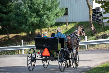 Amish man with his three children in a horse and buggy at an intersection | Holmes County, Ohio,...