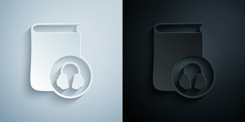 Paper cut Audio book icon isolated on grey and black background. Book with headphones. Audio guide sign. Online learning concept. Paper art style. Vector