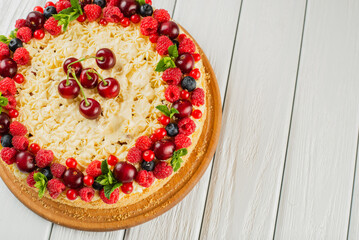 Berry cake decorated with cherries top view