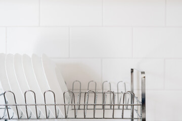 White dishes after washing in special drainer