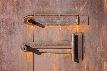 Close up of rusty metal garage door. Rusty metal gate.