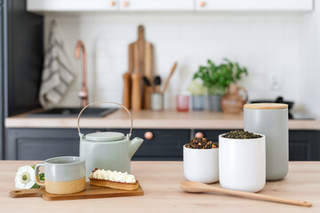 Fototapeta na wymiar Ceylon tea, kettle and eclair on table in kitchen