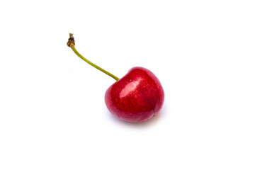 a red cherry lies on a white background