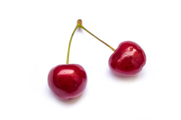 two twin cherries lie on a white background