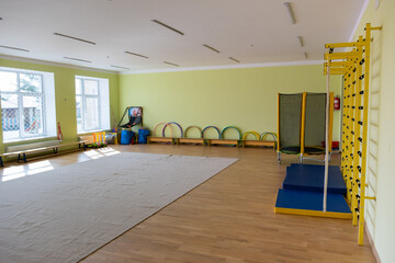Lardge empty elementary school or kindergarten modern gym room with sport and recreational equipment