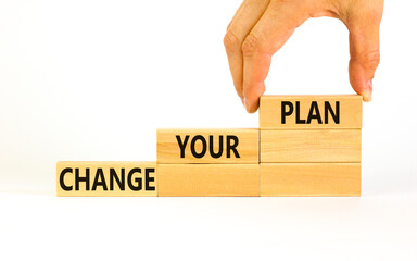 Change your plan symbol. Concept words Change your plan on wooden blocks on a beautiful white table white background. Businessman hand. Business, finacial and change your plan concept. Copy space.