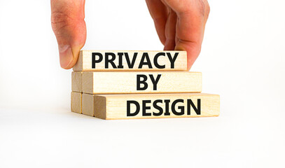 Privacy by design symbol. Concept words Privacy by design on wooden blocks on a beautiful white table white background. Businessman hand. Business finacial and privacy by design concept. Copy space.