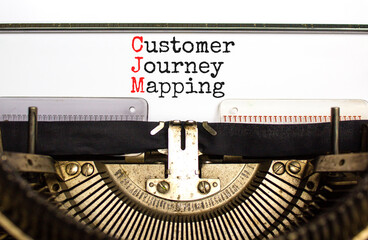 CJM customer journey mapping symbol. Concept words CJM customer journey mapping typed on old retro typewriter on beautiful white background. Business CJM customer journey mapping concept. Copy space.