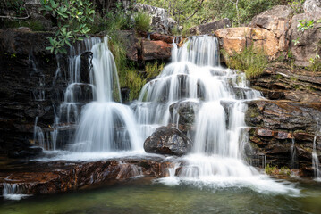 Fototapeta na wymiar Beautiful view to wild waterfall on green area