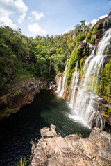 Fototapeta na wymiar Beautiful view to big wild green rocky waterfall