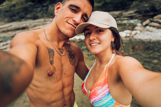 Couple taking selfie while bathing at river. Ca&ntilde;on de A&ntilde;isclo, Huesca.